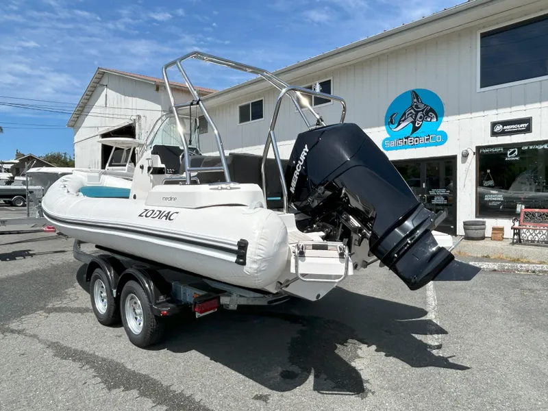 Slide: The Image of 2024 Zodiac Medline 6.8 boat with Mercury engine on trailer outside dealership. - 9