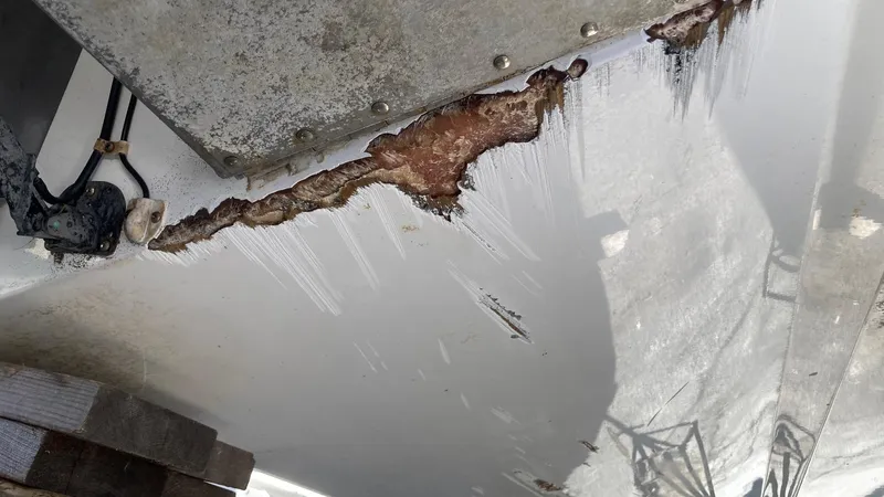 Slide: The Image of Damaged hull of a 2006 Cobalt 263 boat showing significant wear and corrosion. - 10