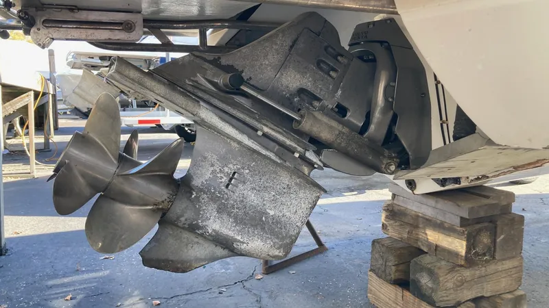 Slide: The Image of 2006 Cobalt 263 boat propeller and stern drive on wooden blocks. - 12