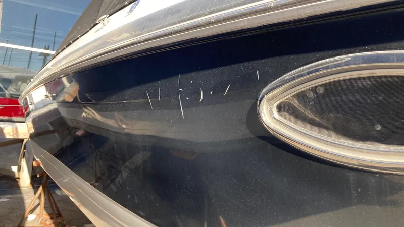 Slide: The Image of 2006 Cobalt 263 boat with visible scratches on the blue hull. - 14