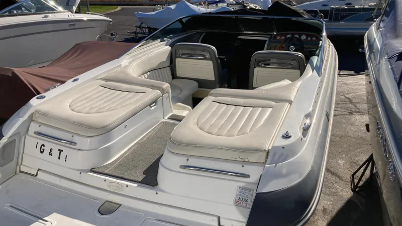 Slide: The Image of 2006 Cobalt 263 boat with white leather seats docked in a marina. - 15