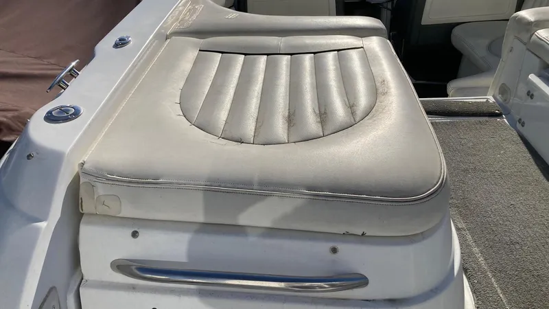 Slide: The Image of 2006 Cobalt 263 boat seat with white upholstery and stainless steel handle. - 17