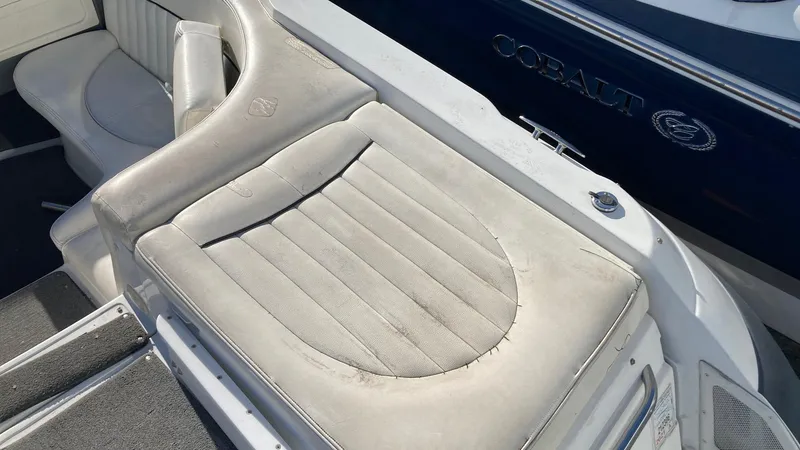 Slide: The Image of 2006 Cobalt 263 boat with worn white leather seating. - 19