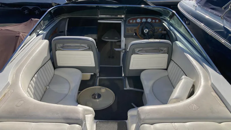 Slide: The Image of 2006 Cobalt 263 boat interior with white leather seating and steering console. - 20