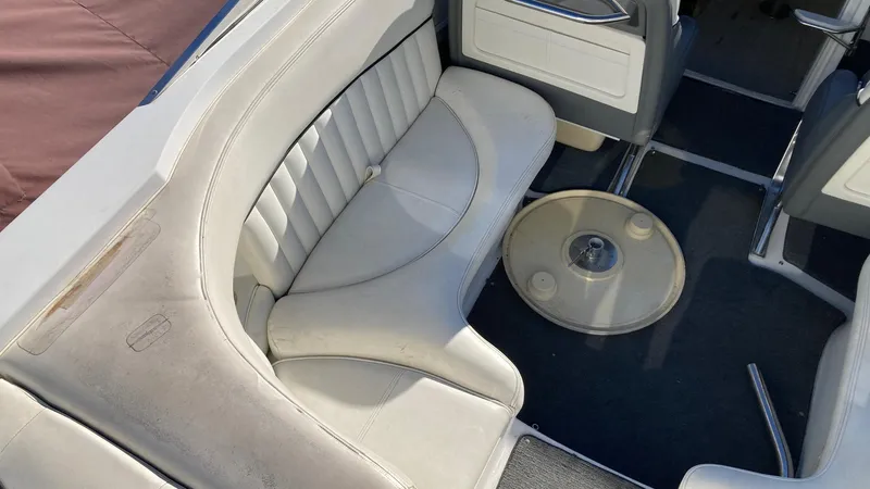 Slide: The Image of 2006 Cobalt 263 boat interior with white leather seating and round table. - 21