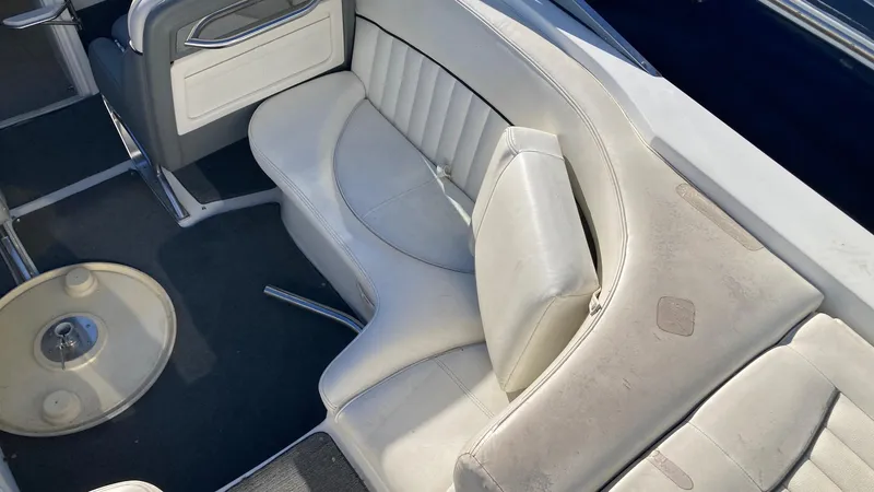 Slide: The Image of 2006 Cobalt 263 boat interior with white leather seating and table. - 22