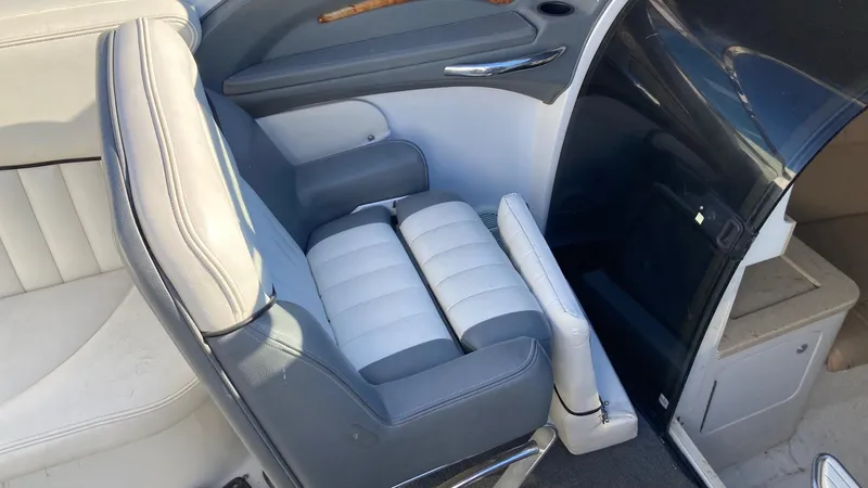 Slide: The Image of 2006 Cobalt 263 boat interior with white and gray seating. - 24
