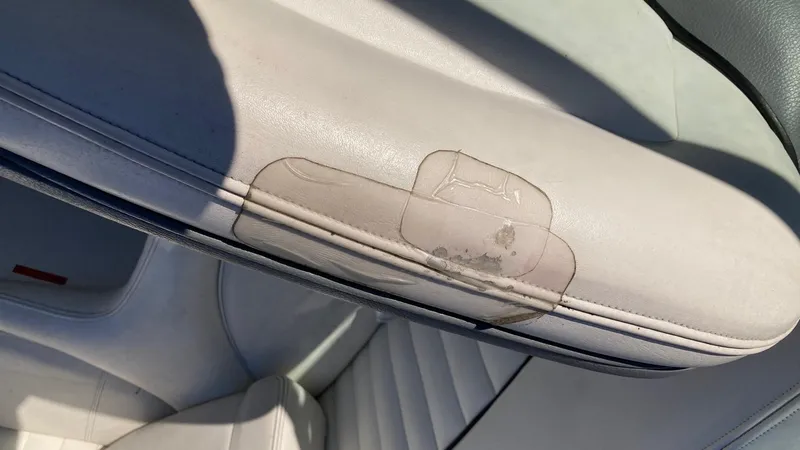 Slide: The Image of 2006 Cobalt 263 boat interior with worn upholstery. - 26