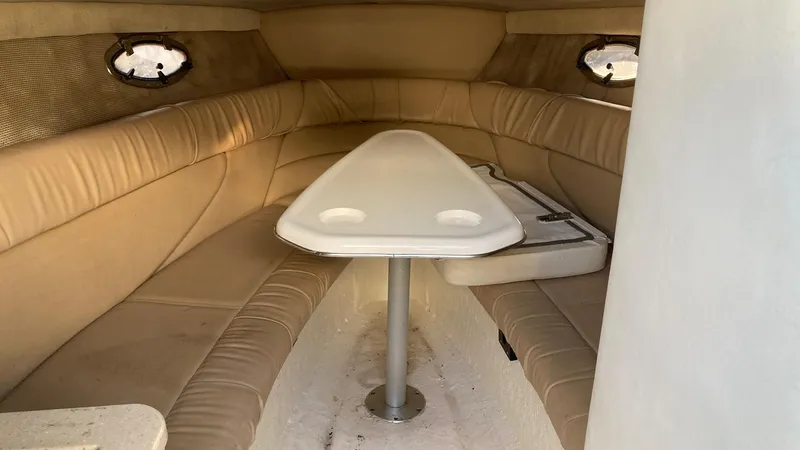 Slide: The Image of Interior cabin of a 2006 Cobalt 263 boat with beige seating and a white table. - 27