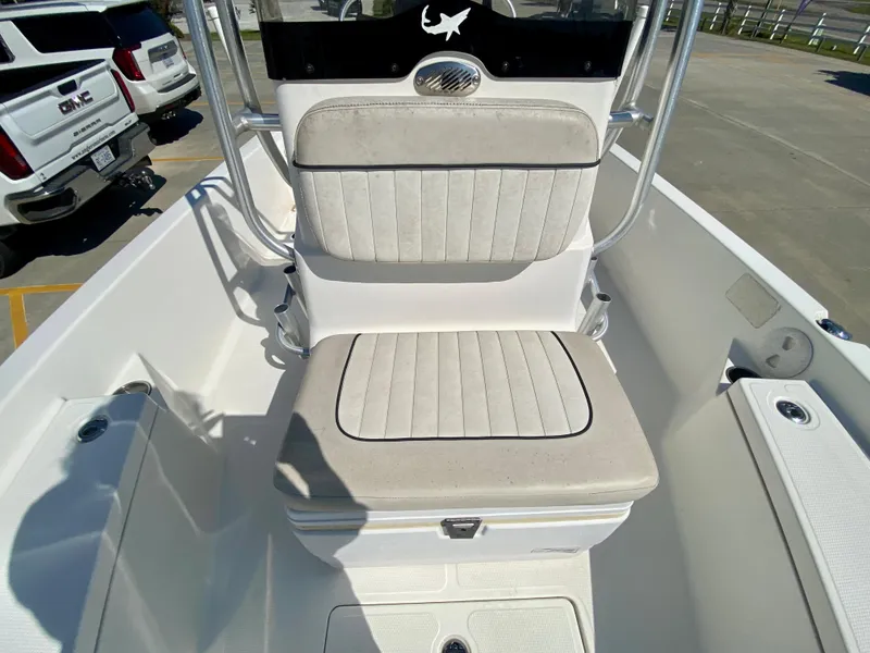 Slide: The Image of 2017 Mako 19 CPX boat with cushioned seating and storage compartment. - 13
