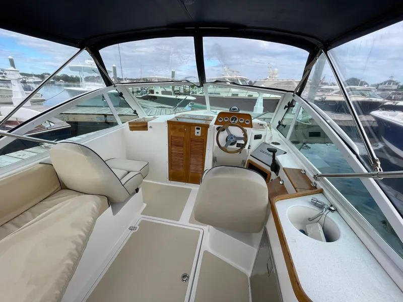 Slide: The Image of 2005 Hunt Yachts Harrier 25 cockpit with helm station and seating at marina. - 3