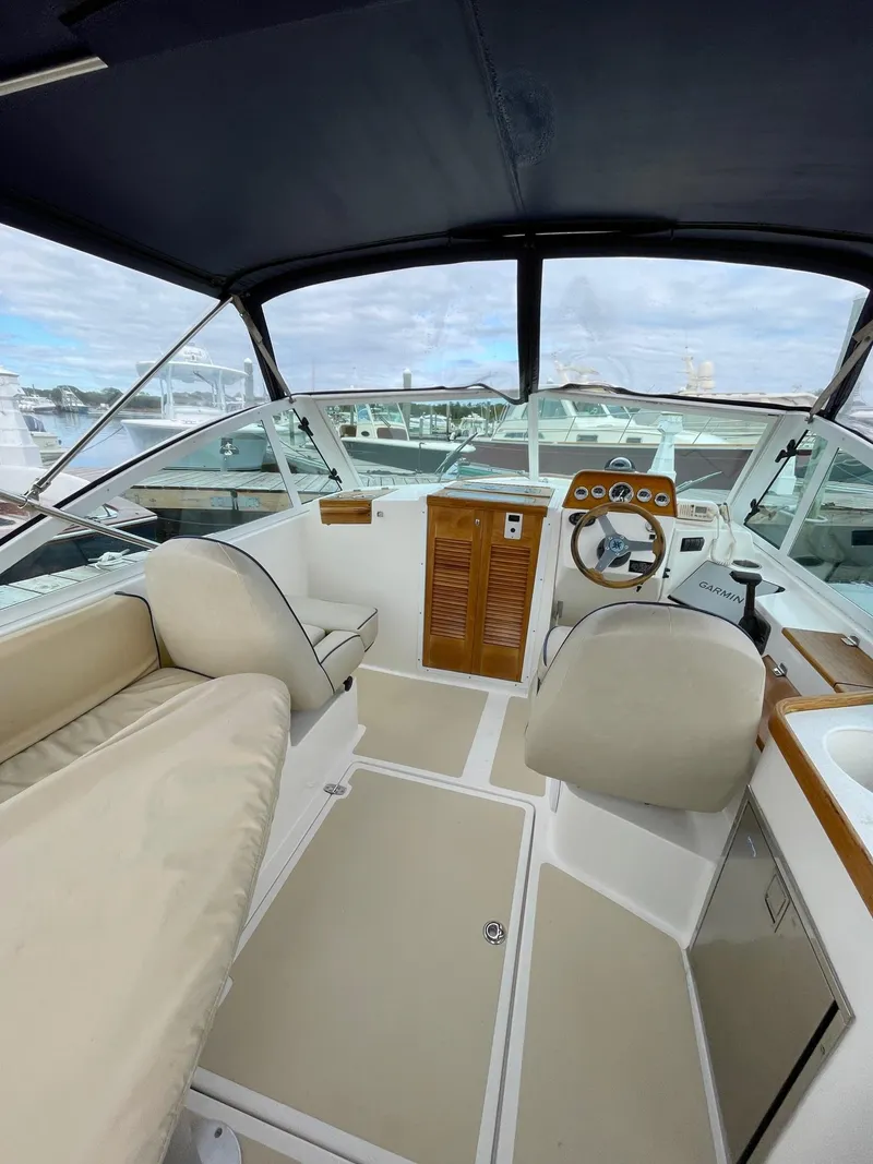 Slide: The Image of 2005 Hunt Yachts Harrier 25 interior with helm, seating, and covered deck. - 5