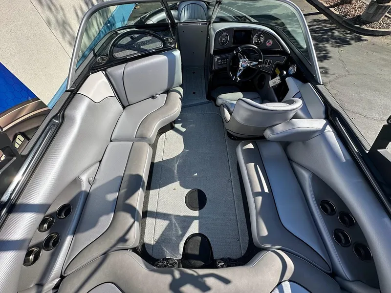 Slide: The Image of 2024 Sanger V215 SX boat interior with gray seating and modern dashboard. - 11