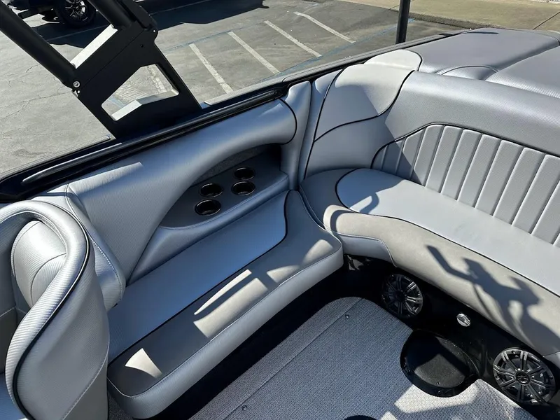 Slide: The Image of 2024 Sanger V215 SX boat interior with gray leather seating and cup holders. - 12