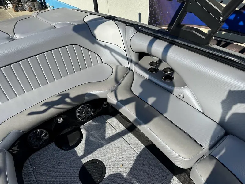 Slide: The Image of 2024 Sanger V215 SX boat interior with gray seating and cup holders. - 14