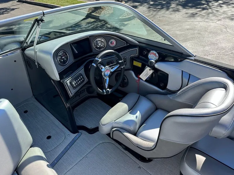 Slide: The Image of 2024 Sanger V215 SX boat interior with modern dashboard and comfortable seating. - 15