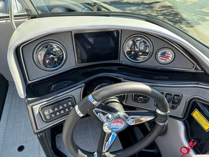 Slide: The Image of 2024 Sanger V215 SX boat dashboard with steering wheel and control panel. - 16
