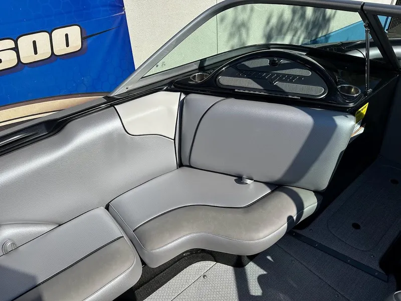 Slide: The Image of 2024 Sanger V215 SX boat interior with gray seating and steering console. - 18