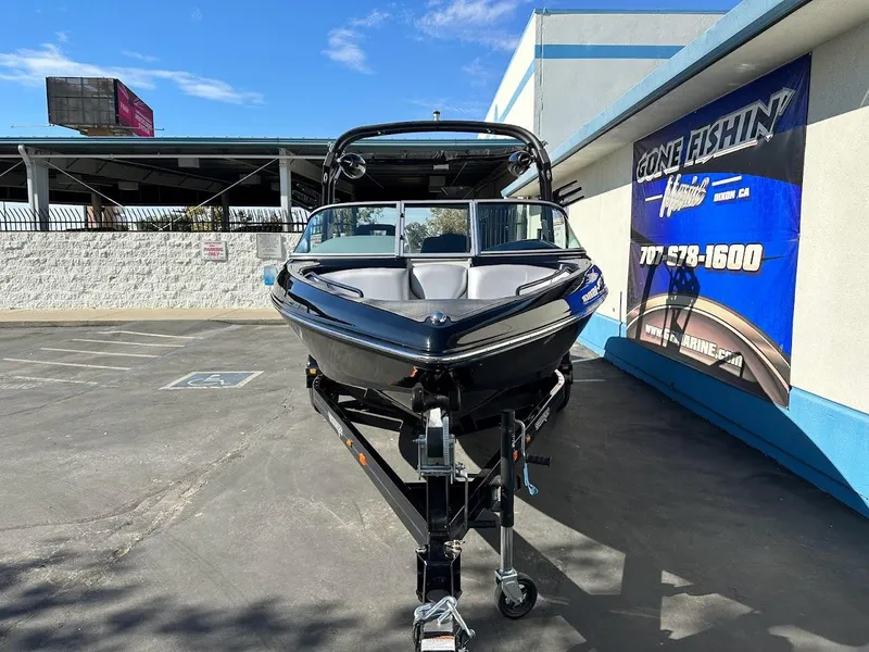 Slide: The Image of 2024 Sanger V215 SX boat on trailer at dealership. - 2