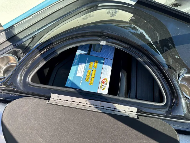 Slide: The Image of 2024 Sanger V215 SX boat storage compartment with a blue box inside. - 20