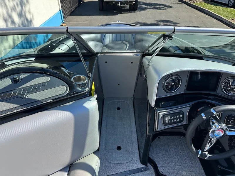 Slide: The Image of 2024 Sanger V215 SX boat interior, steering wheel, and dashboard. - 23