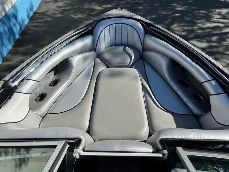 Slide: The Image of 2024 Sanger V215 SX boat interior with gray cushioned seating. - 24