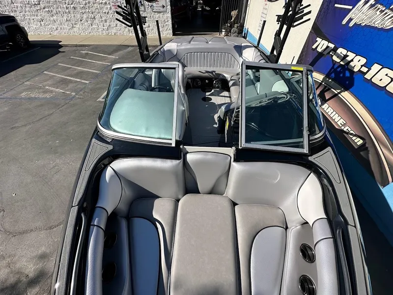 Slide: The Image of 2024 Sanger V215 SX boat interior with open windshield and gray seating. - 25