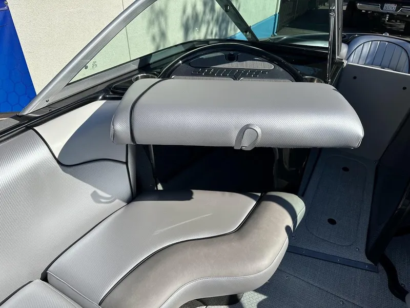 Slide: The Image of 2024 Sanger V215 SX boat interior with grey seating and dashboard. - 27