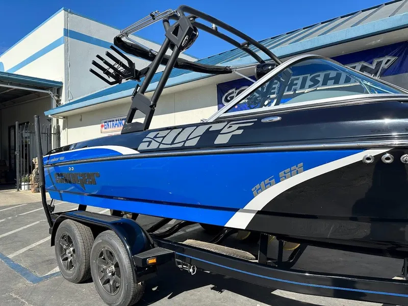 Slide: The Image of 2024 Sanger V215 SX boat in blue and black on a trailer. - 3