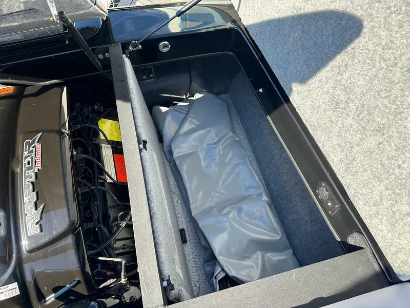 Slide: The Image of 2024 Sanger V215 SX boat engine compartment with storage area. - 32