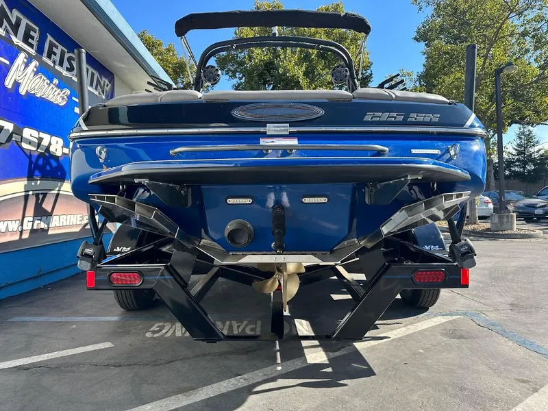 Slide: The Image of 2024 Sanger V215 SX boat rear view in a parking lot. - 7