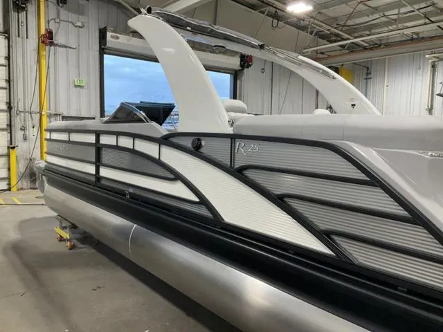 Slide: The Image of 2023 Bennington 25 RFBWA Quad Bench Tritoon in a workshop. - 5