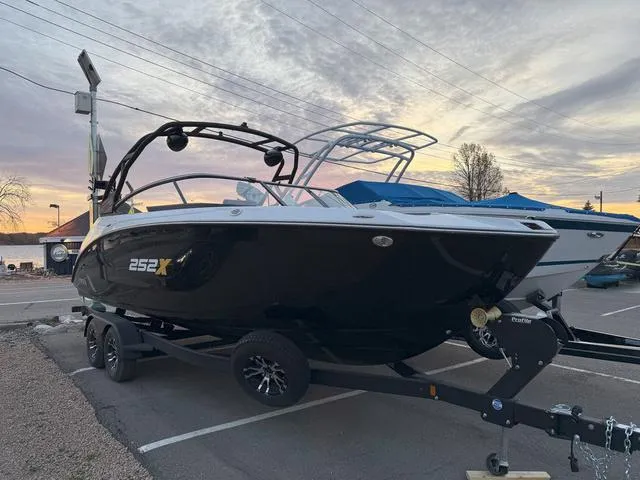 Slide: The Image of 2023 Yamaha Boats 252XE, black, on trailer, side view. - 2