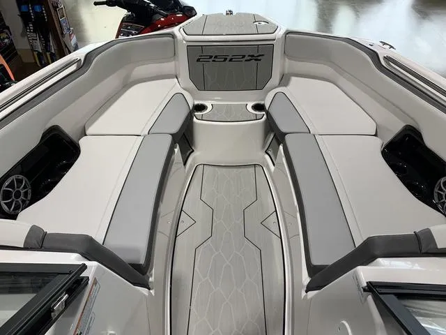 Slide: The Image of 2023 Yamaha Boats 252XE storage compartment with a cardboard box inside. - 21
