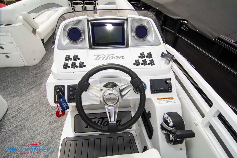 Slide: The Image of 2023 JC NEPTOON 27 TT SPORT boat dashboard with steering wheel and control panel. - 21
