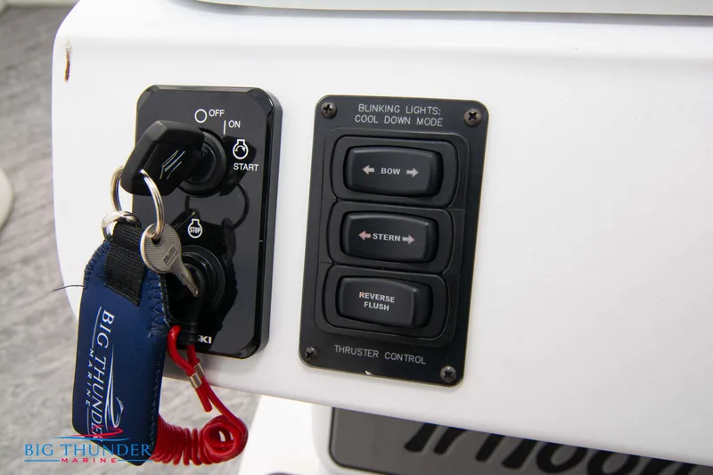Slide: The Image of Control panel of 2023 JC NEPTOON 27 TT SPORT boat with keys and thruster controls. - 27