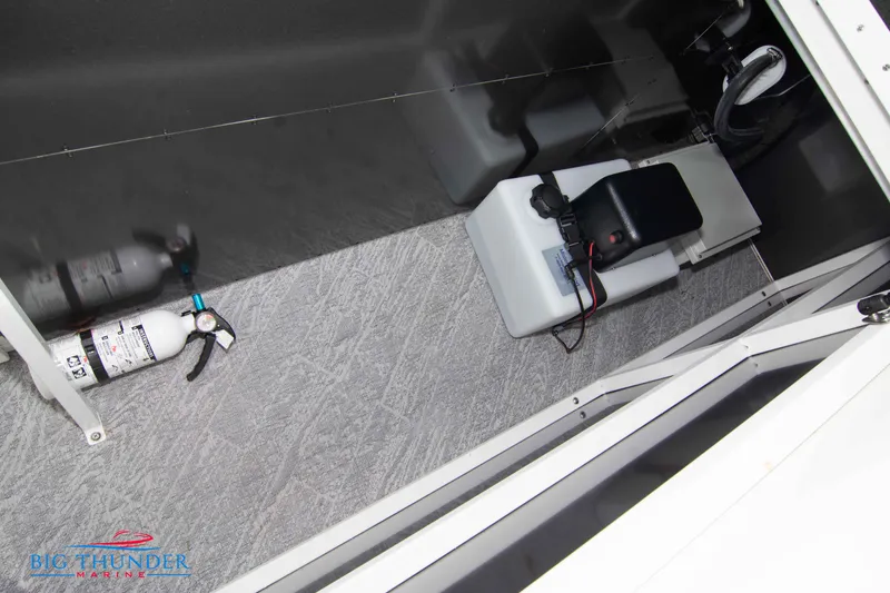 Slide: The Image of 2023 JC NEPTOON 27 TT SPORT storage compartment with fire extinguisher and battery. - 37