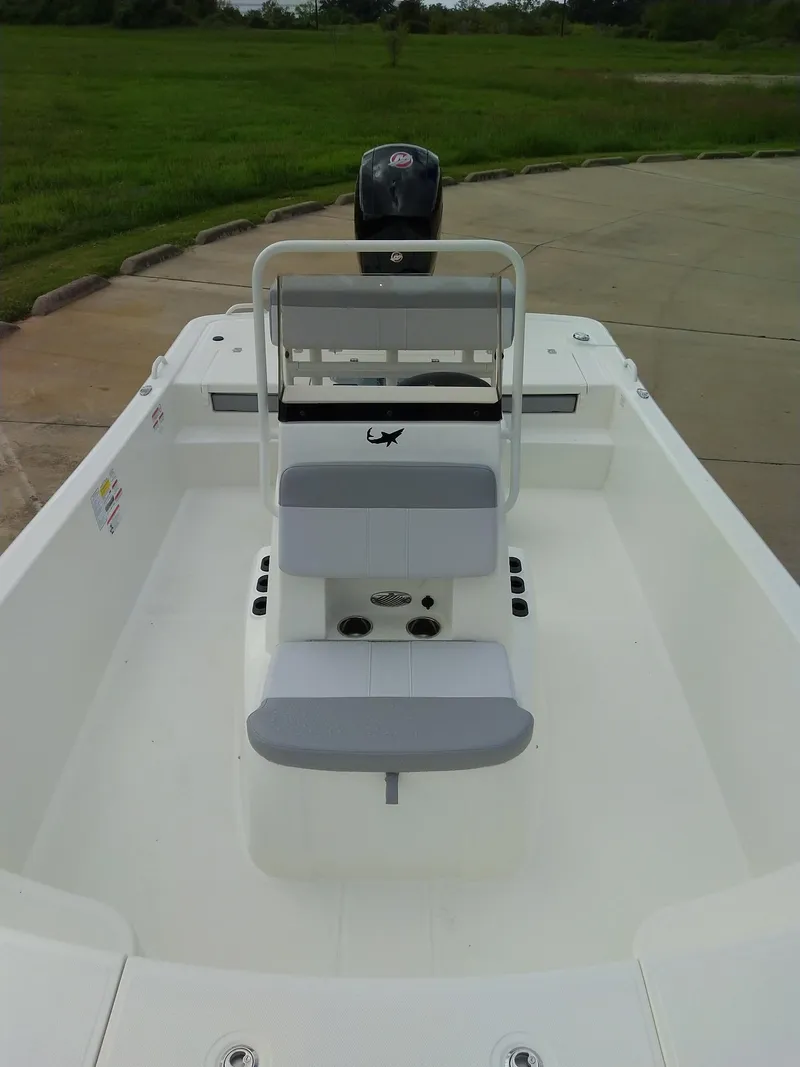 Slide: The Image of 2024 Mako Pro Skiff 19 CC boat interior with seating and console. - 2