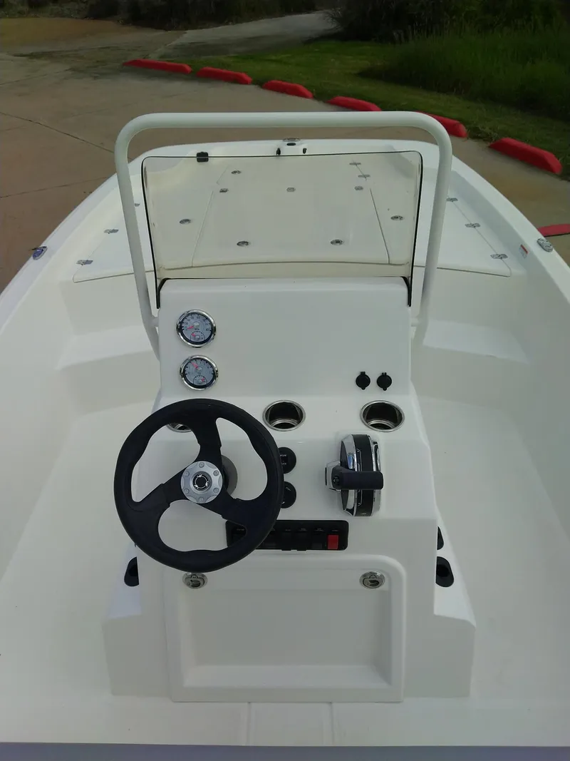 Slide: The Image of 2024 Mako Pro Skiff 19 CC center console with steering wheel and controls. - 3