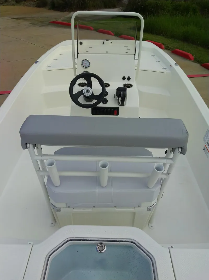 Slide: The Image of 2024 Mako Pro Skiff 19 CC center console boat interior with steering wheel and seating. - 4