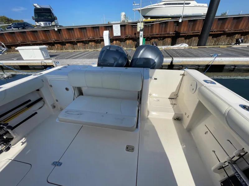 Slide: The Image of 2011 Pursuit 280 Center Console boat with twin engines docked at a marina. - 12