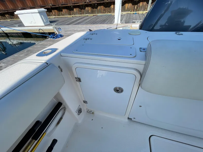 Slide: The Image of 2011 Pursuit 280 Center Console boat interior, featuring storage compartments and seating. - 13