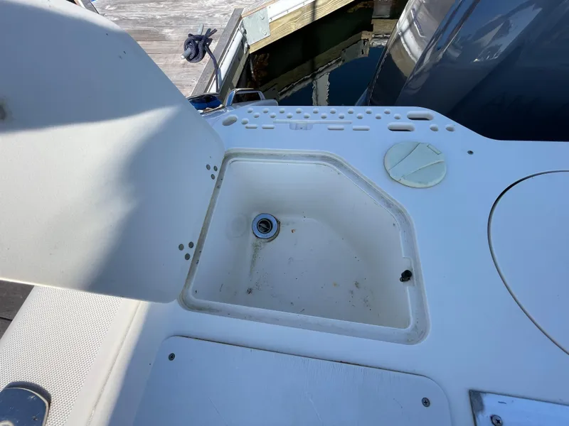 Slide: The Image of 2011 Pursuit 280 Center Console boat sink and storage compartment. - 14
