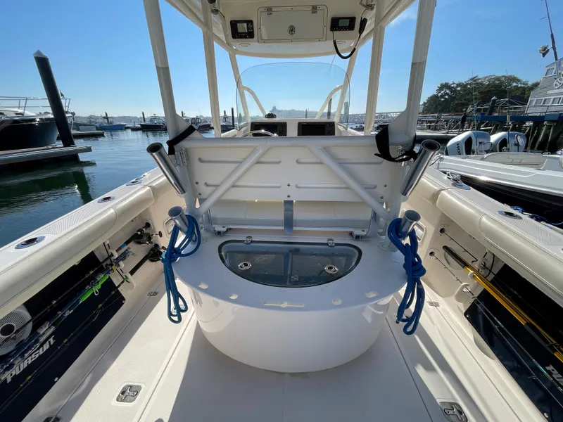 Slide: The Image of 2011 Pursuit 280 Center Console boat docked at a marina. - 17