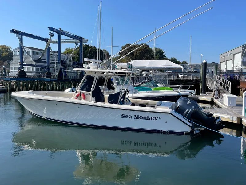 Slide: The Image of 2011 Pursuit 280 Center Console boat docked at a marina. - 2