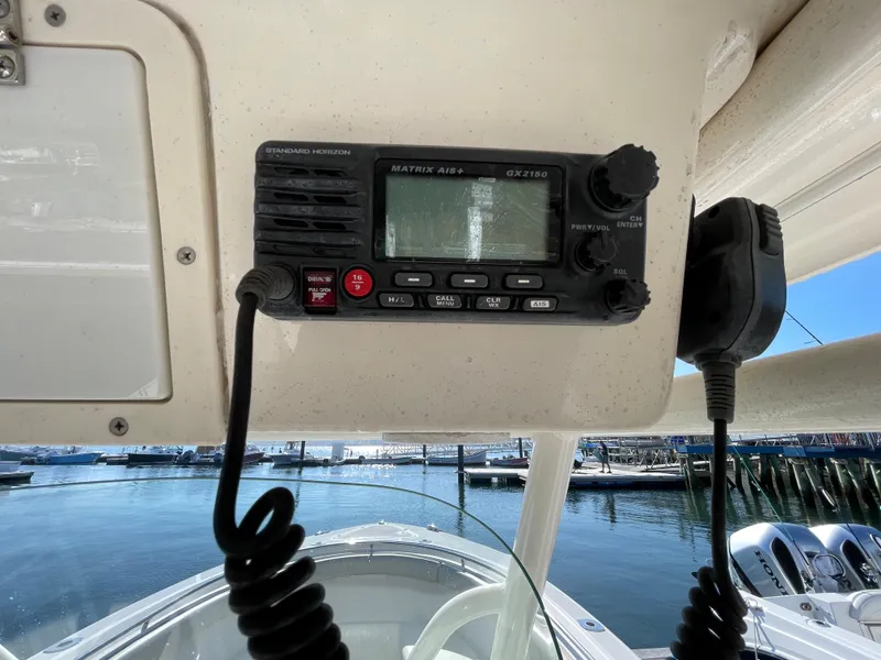 Slide: The Image of 2011 Pursuit 280 Center Console boat with marine radio and waterfront view. - 30