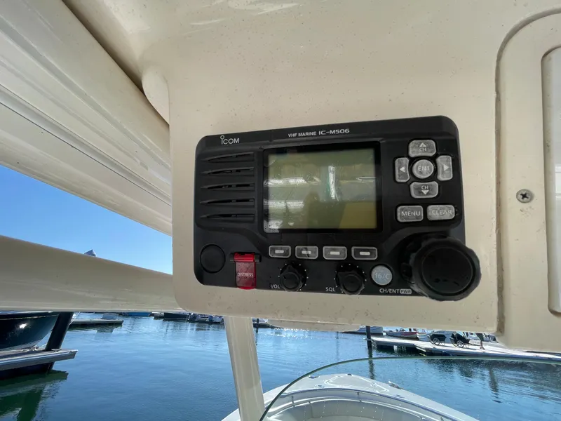 Slide: The Image of ICOM marine radio on a 2011 Pursuit 280 Center Console boat at a marina. - 31