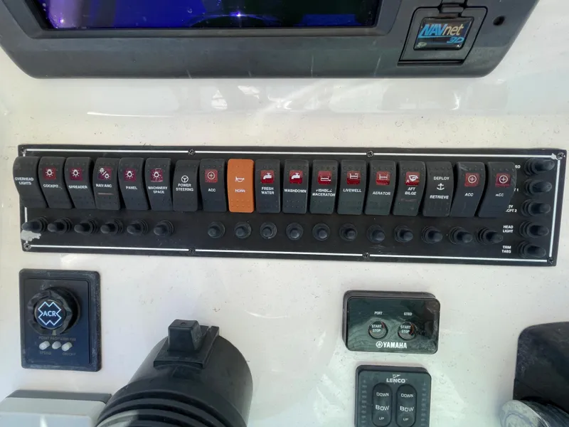 Slide: The Image of Control panel of a 2011 Pursuit 280 Center Console boat with various switches and buttons. - 33
