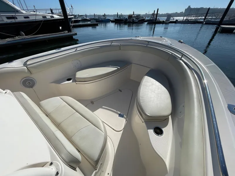 Slide: The Image of 2011 Pursuit 280 Center Console boat interior with seating, docked at marina. - 37