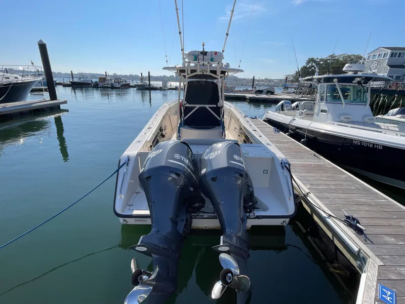 Slide: The Image of 2011 Pursuit 280 Center Console boat docked with twin outboard engines. - 4